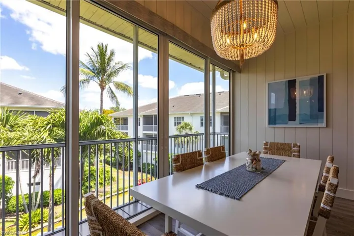 Sunroom / solarium featuring a notable chandelier