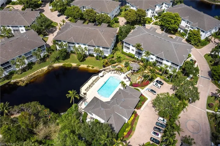 Drone / aerial view with a residential view and a water view
