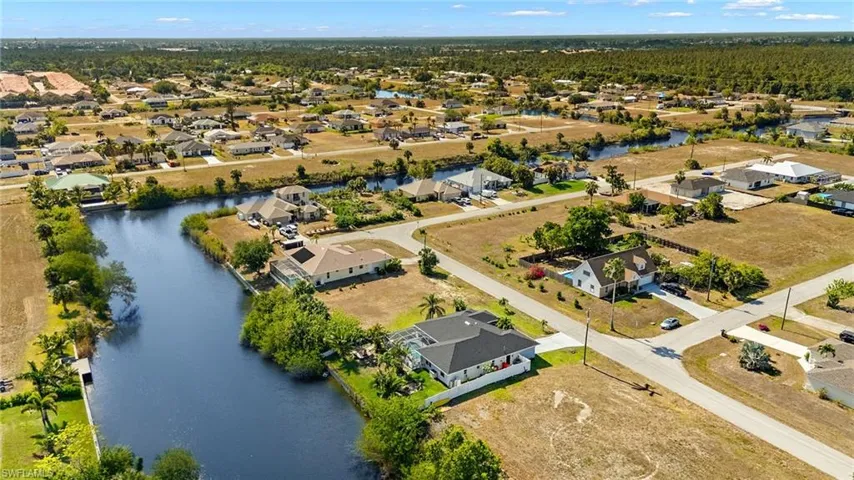 Drone / aerial view with a residential view and a water view
