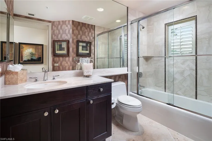 Full bath with vanity, enclosed tub / shower combo, and recessed lighting
