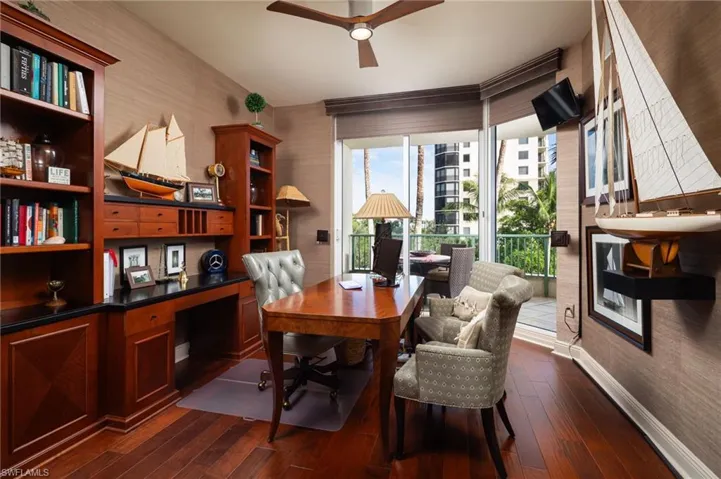 Office area featuring dark wood-type flooring and a ceiling fan
