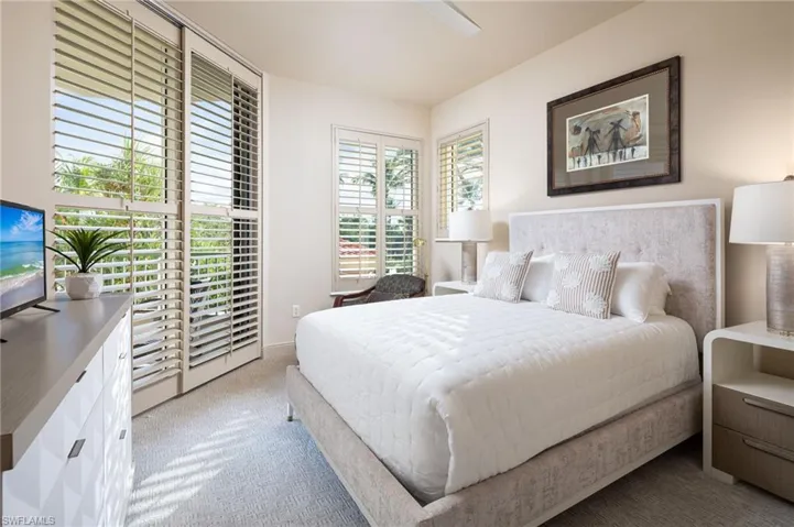 Bedroom featuring light colored carpet and a ceiling fan