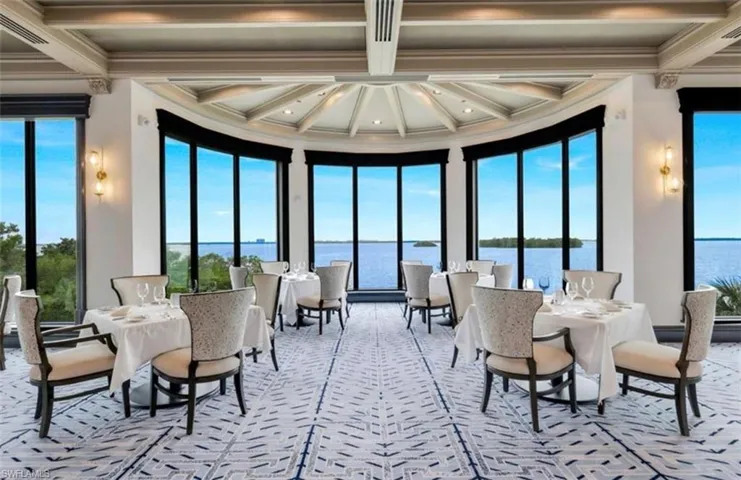 Sunroom featuring a water view, beamed ceiling, crown molding, and coffered ceiling