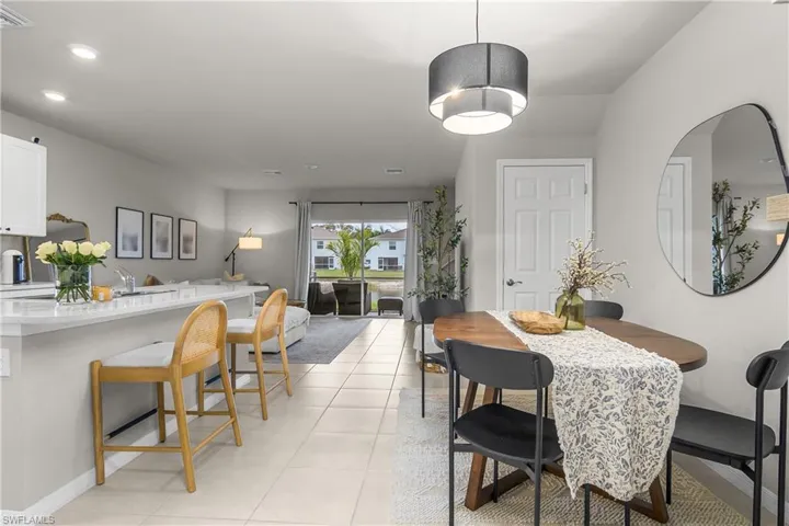 Dining area with light tile patterned floors and baseboards