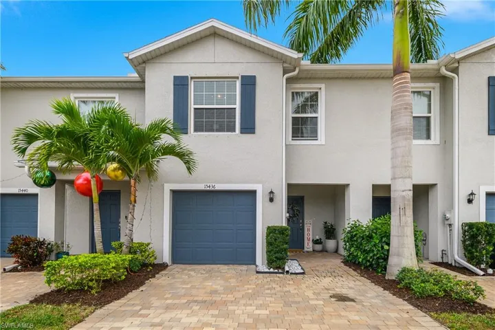 View of front of house featuring stucco siding and decorative driveway