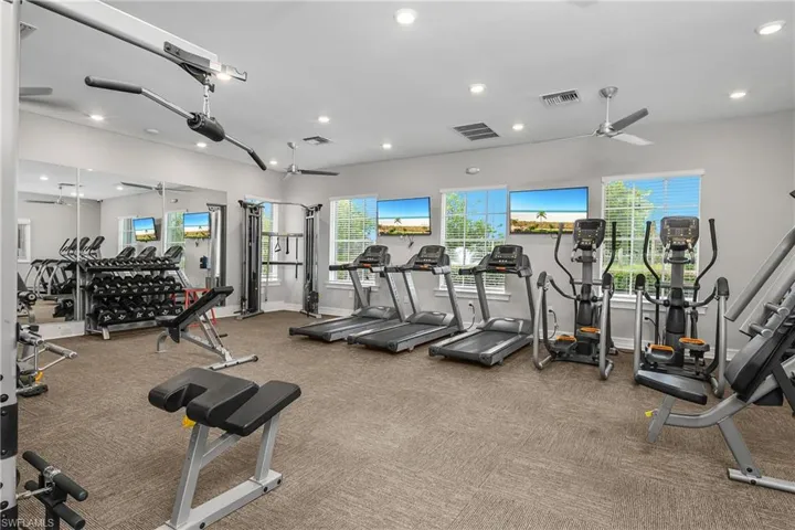 Gym featuring ceiling fan and recessed lighting