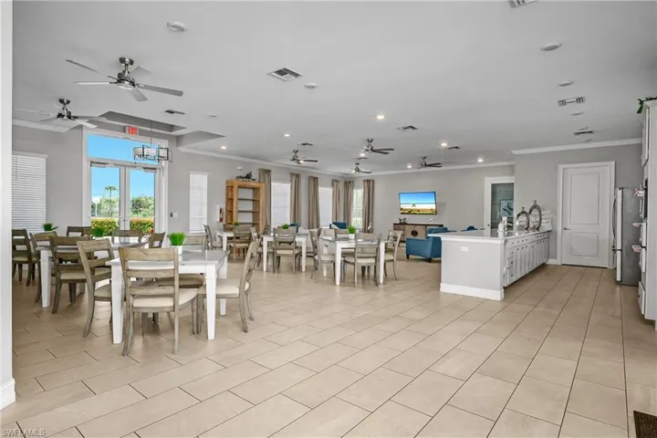 Dining area with crown molding, plenty of natural light, and ceiling fan