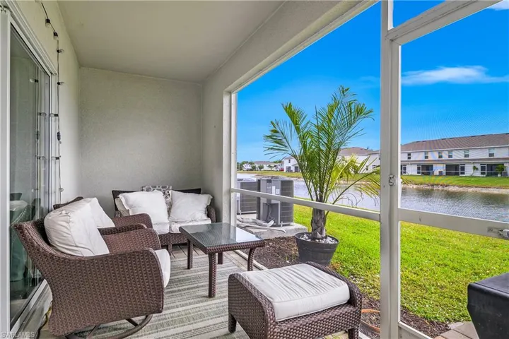 Sunroom featuring a water view
