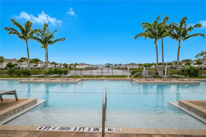 Community pool with a patio and a residential view