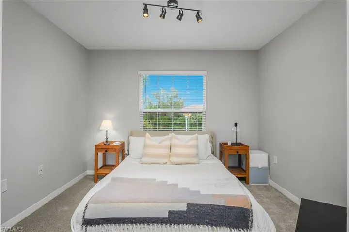 Bedroom featuring light colored carpet