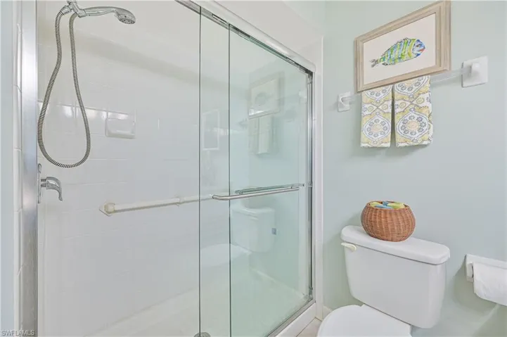 Full bathroom with a stall shower and toilet