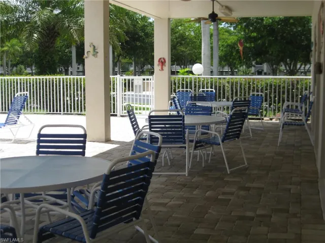 Shaded Pool area featuring a ceiling fan, outdoor dining area, and fence