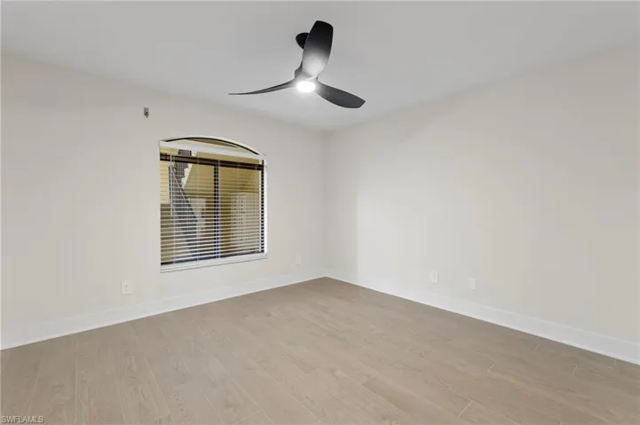 Empty room featuring light wood finished floors and ceiling fan