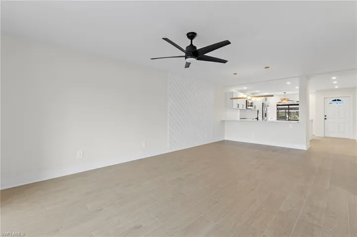 Unfurnished living room featuring light wood-type flooring, recessed lighting, and ceiling fan