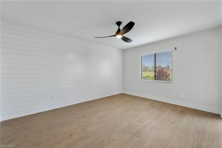 Spare room with light wood finished floors and ceiling fan