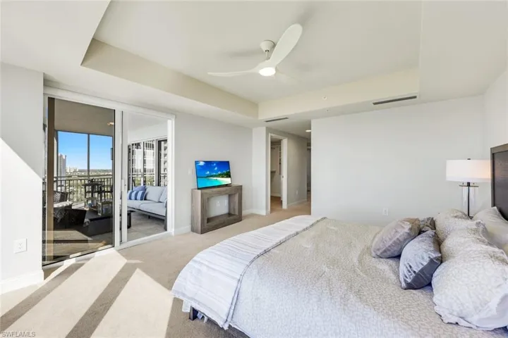 Spacious primary suite with floor to ceilingwindows and lanai access.