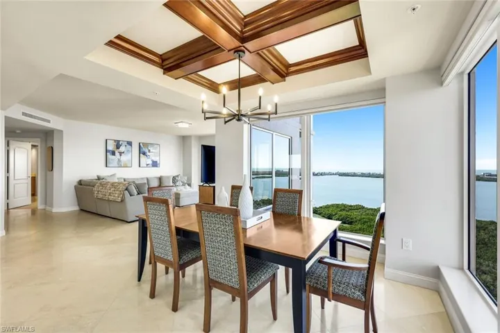 Custom woodwork accents the dining room ceiling.