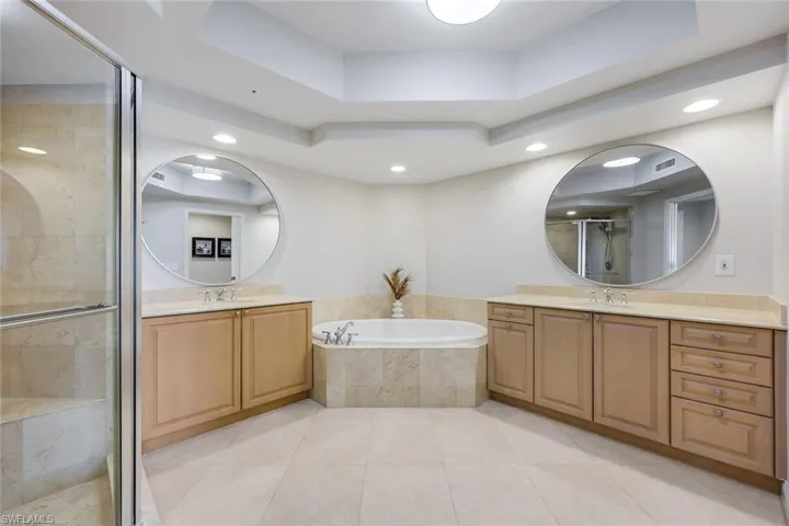 En suite bath offers spa-inspired relaxationwith dual vanities and soaking tub.