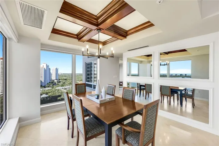 Dining area framed by custom lighting andoutdoor views.