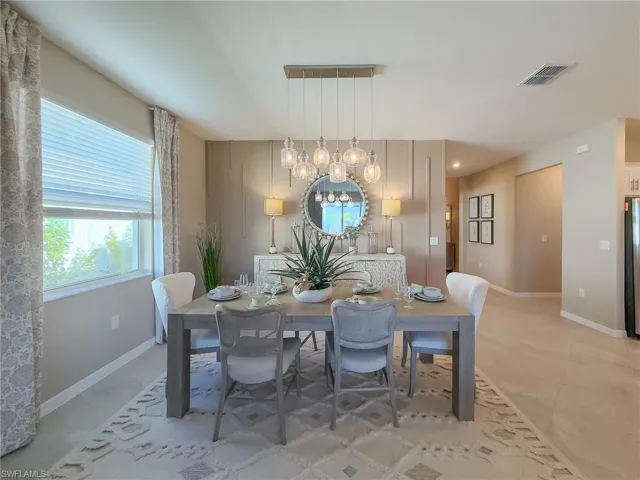 Dining room with a chandelier and baseboards
