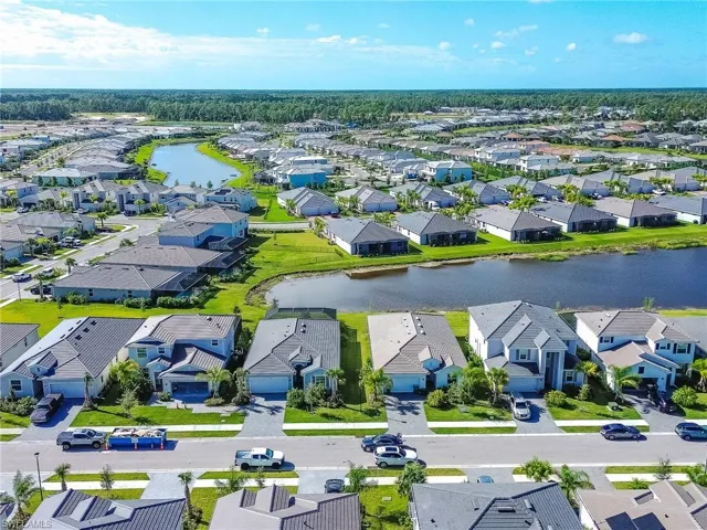 Aerial perspective of suburban area featuring a nearby body of water