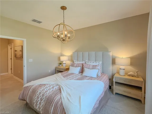 Tiled bedroom with a chandelier