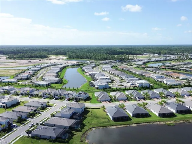 Aerial overview of property's location featuring a nearby body of water and nearby suburban area