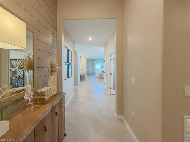Corridor with light tile patterned floors and recessed lighting