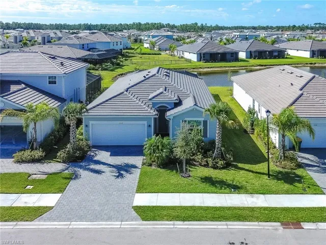 Aerial perspective of suburban area featuring a large body of water