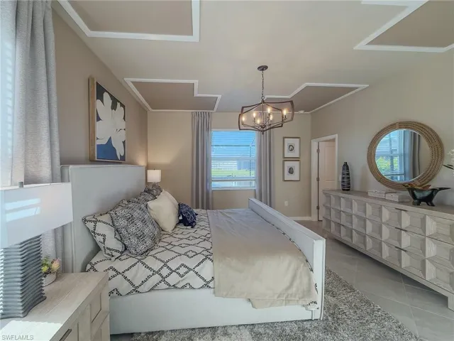 Bedroom with tile patterned flooring and a chandelier