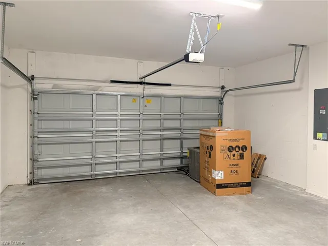 Garage with electric panel and a garage door opener