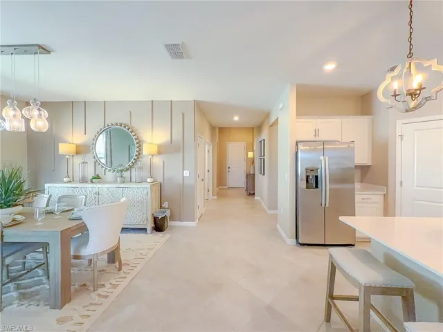 Kitchen featuring decorative light fixtures, a chandelier, stainless steel fridge with ice dispenser, and recessed lighting