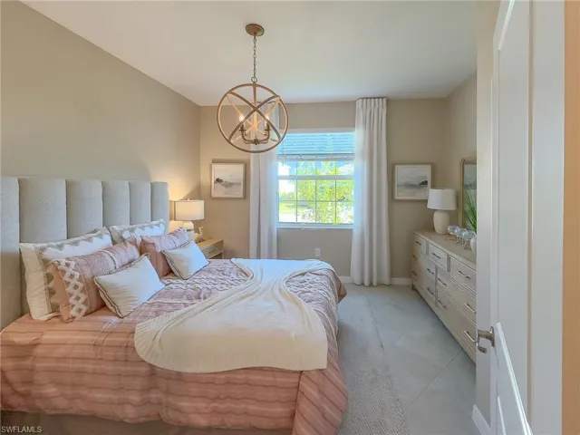 Bedroom with a chandelier and light tile patterned flooring