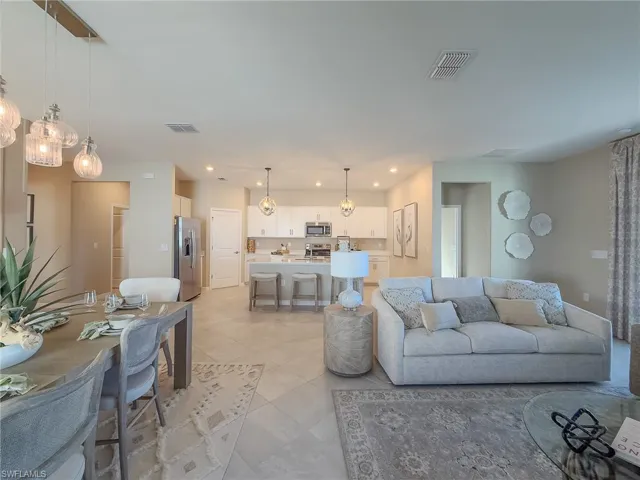 Living area featuring a chandelier, recessed lighting, and light tile patterned floors