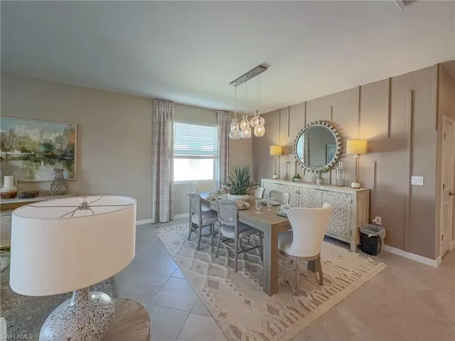 Dining area with tile patterned flooring and a chandelier