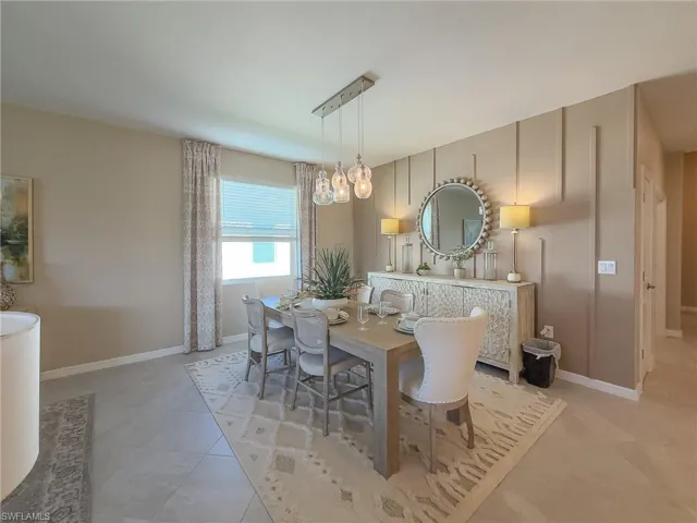 Dining space featuring baseboards and light tile patterned flooring