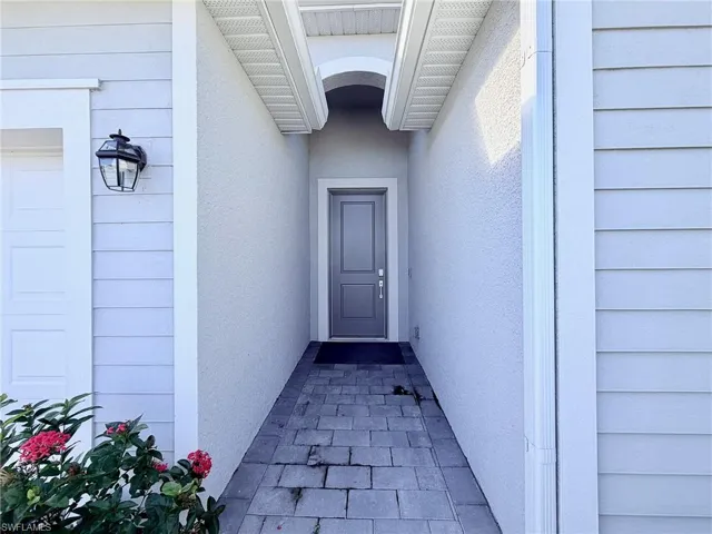 Property entrance featuring stucco siding