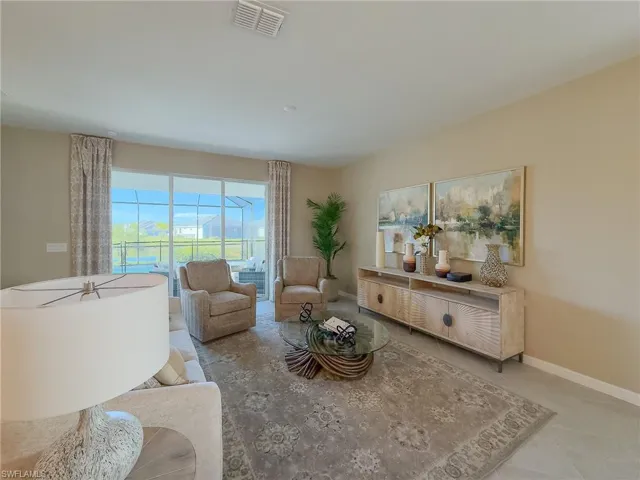 Living room with baseboards and tile patterned floors