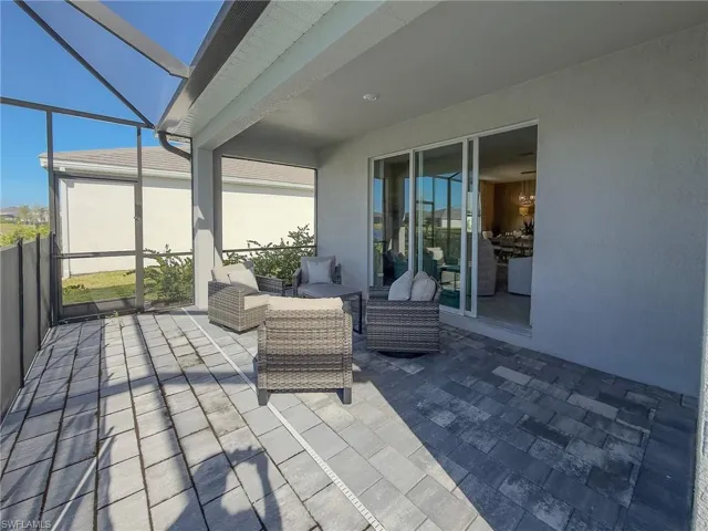 View of patio featuring a sunroom and a lanai