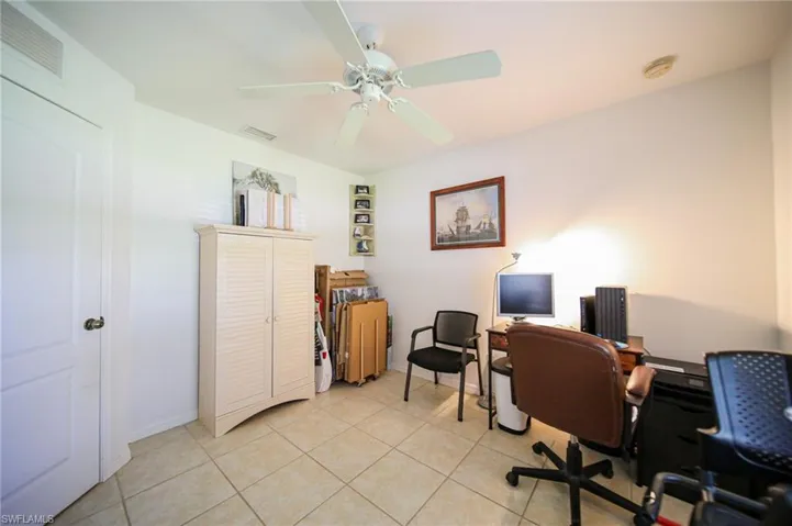 Bedroom #3 has a large walk-in closet, tile flooring, and ceiling fan.