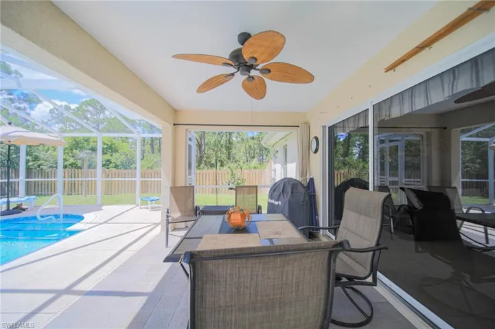 Sunroom featuring ceiling fan