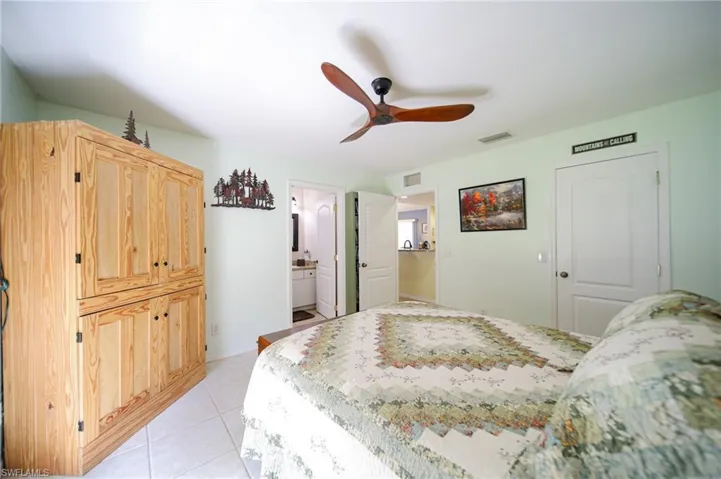 The Master Bedroom With Private Master Bathroom, Custom Ceiling Fan, And Tile On The Diagonal!
