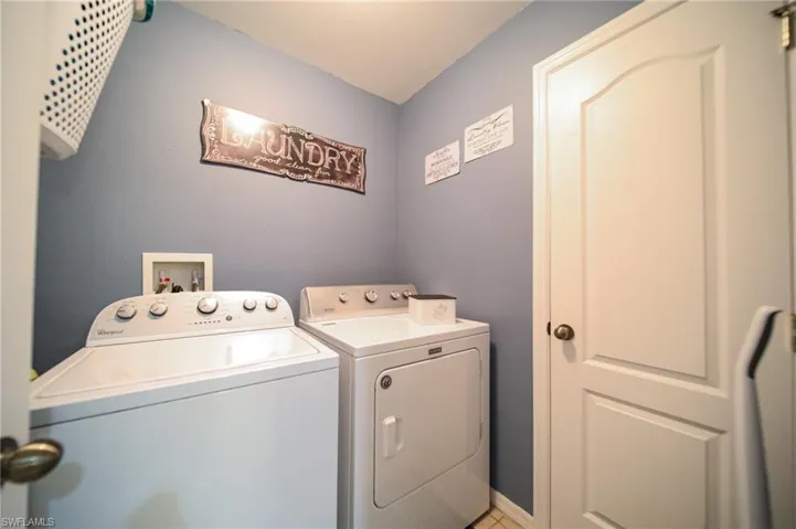 Washroom with washer and clothes dryer