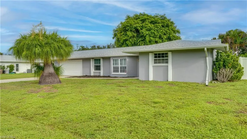 Single-story residence featuring a neutral exterior, white trim accents, and an attached 2-car garage.