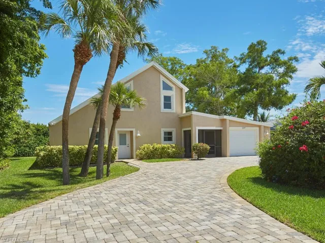 View of front of home with a front lawn and a garage