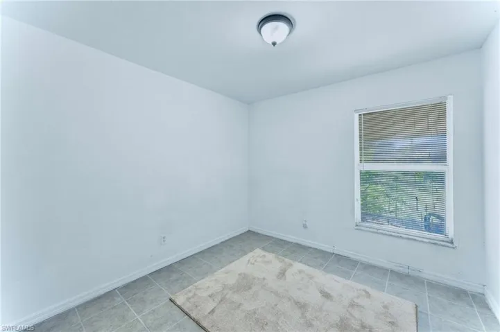 Tiled spare room with baseboards