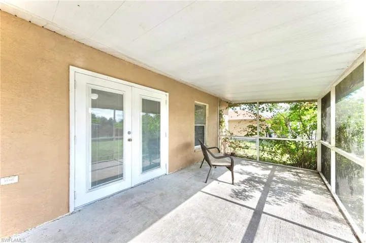 Unfurnished sunroom featuring french doors