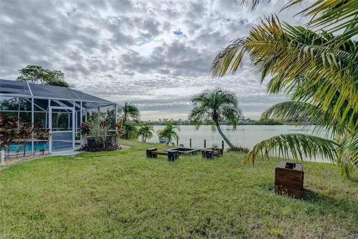 View of yard with a water view and a lanai