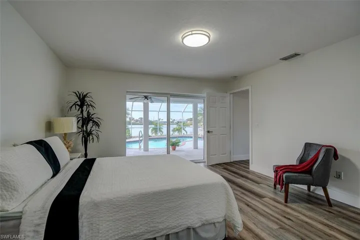 Bedroom with access to outside and hardwood / wood-style flooring