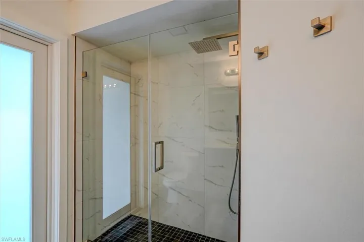 Bathroom with a shower with door